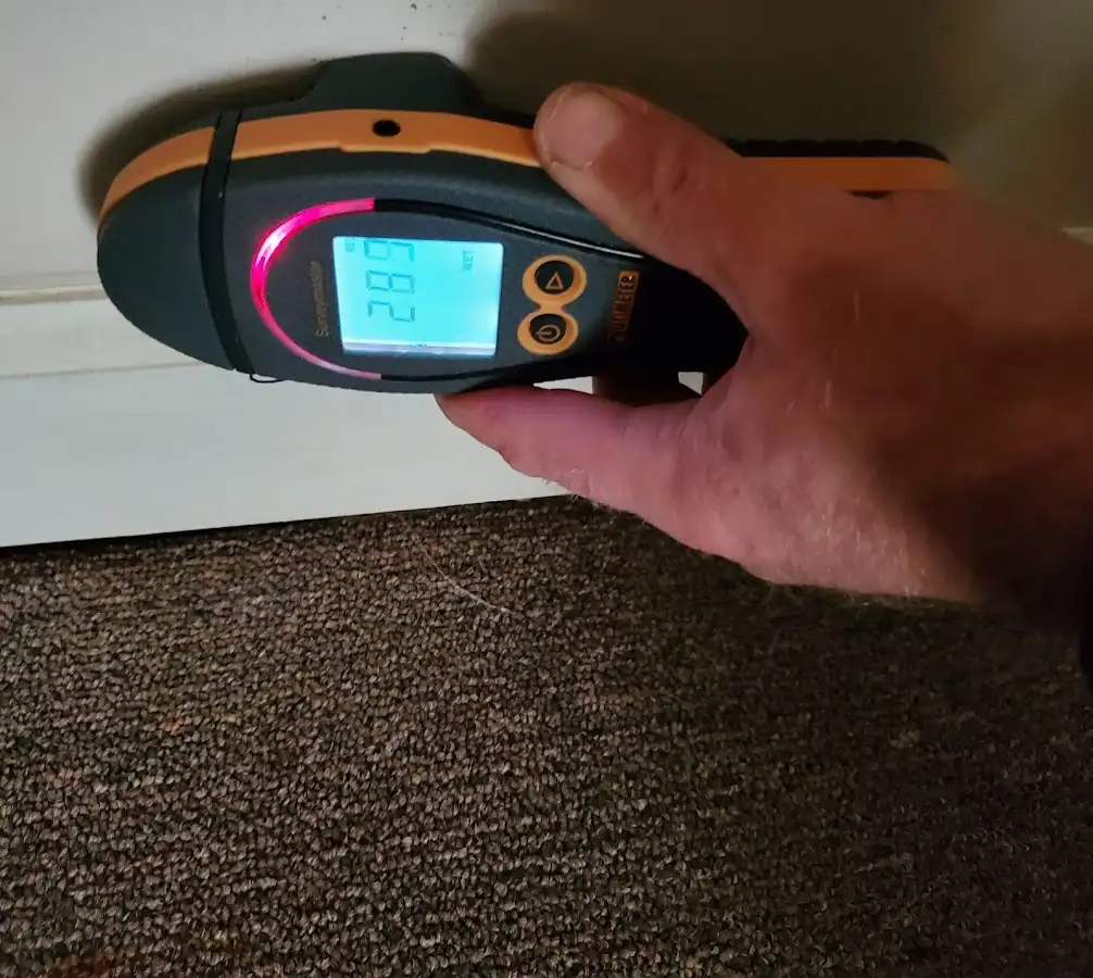 Moisture detection at baseboard during Storm Damage Restoration in Draper